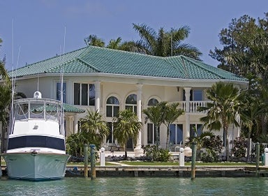 Luxury waterfront estate with yacht docked outside